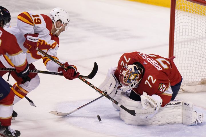 Florida Panthers goaltender Sergei Bobrovsky (72) defends the goal against Calgary Flames left wing Matthew Tkachuk (19) during the third period of an NHL hockey game, Tuesday, Jan. 4, 2022, in Sunrise, Fla. The Panthers won 6-2.