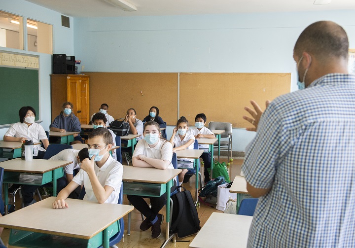 Students wear face masks as they attend class. 