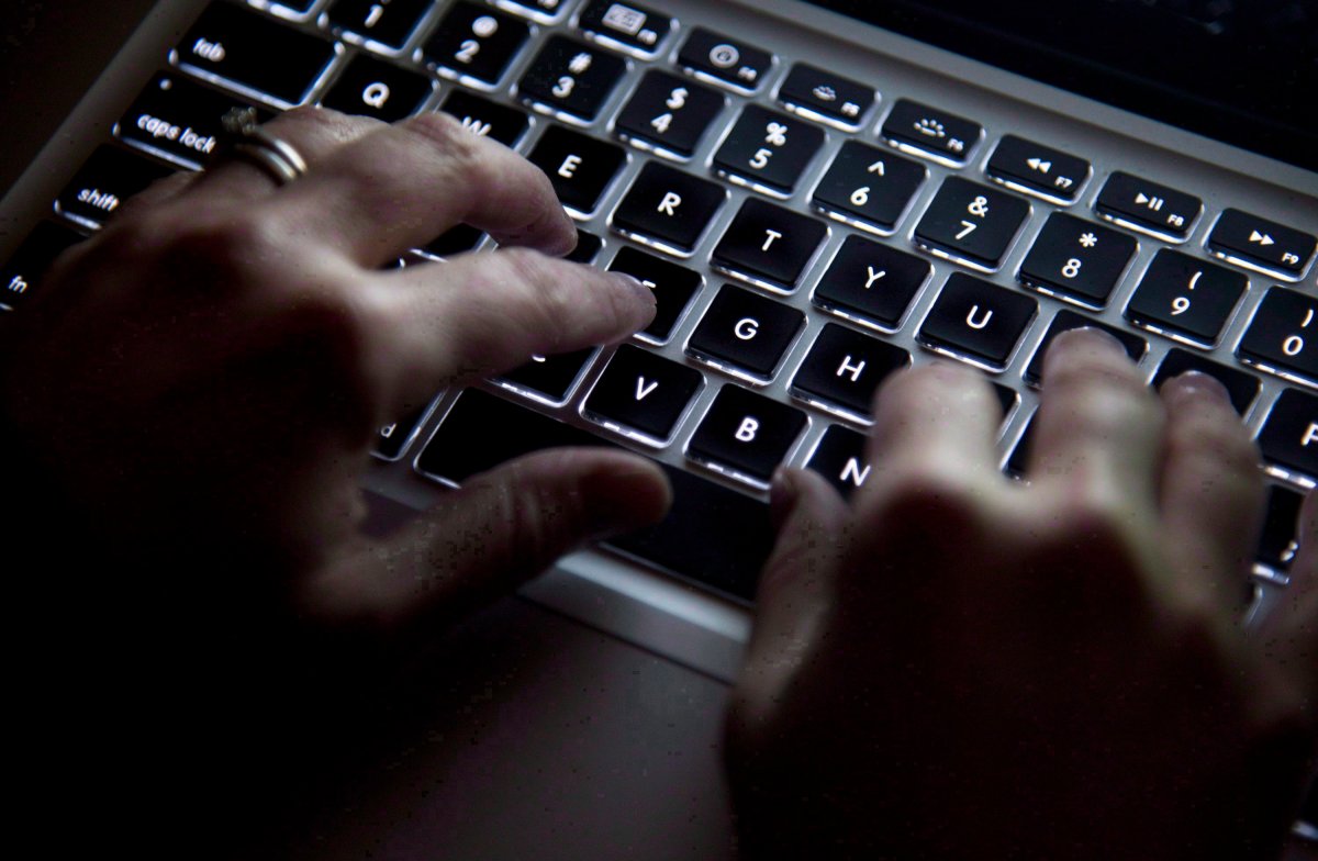 FILE - A woman types on her computer keyboard.