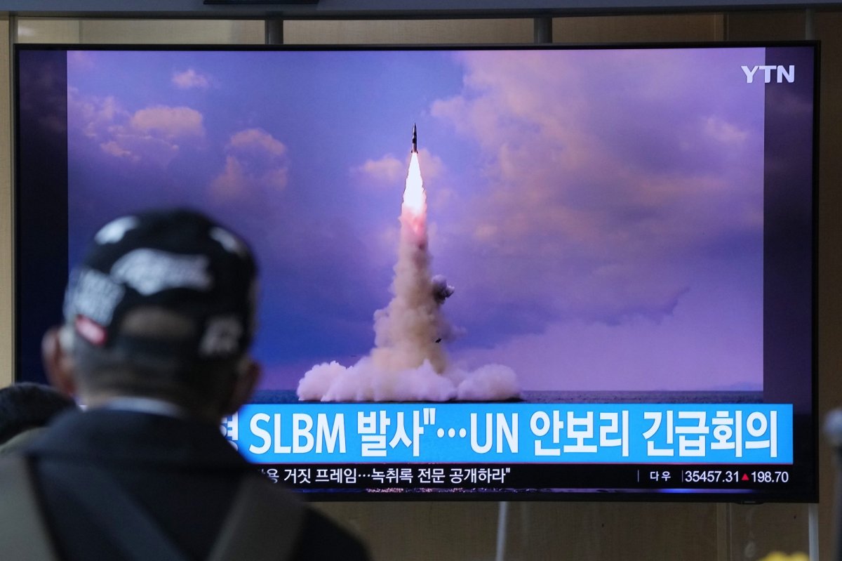 FILE - A man watches a TV screen showing an image of North Korea's ballistic missile launched from a submarine during a news program at Seoul Railway Station in Seoul, South Korea, Wednesday, Oct. 20, 2021. North Korea announced Wednesday that it had tested a newly developed missile designed to be launched from a submarine, the first such weapons test in two years and one it says will bolster its military's underwater operational capability. Korean letters read: "North Korea launched a Submarine-Launched Ballistic Missile and U.N. security council emergency meeting." (AP Photo/Ahn Young-joon).