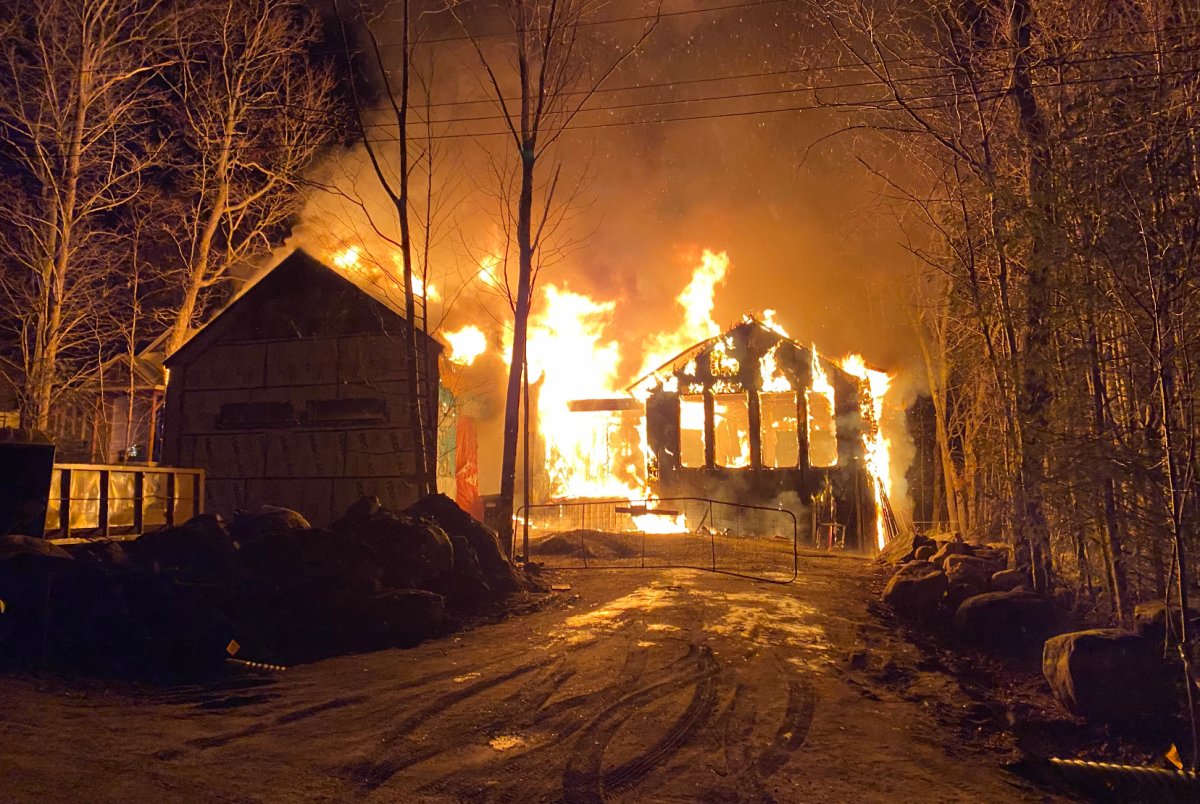 Paul Stanczak and Danielle Bablich's cottage, which was still under construction, is seen on fire in a suspected case of arson which left the structure, near Ontario's Georgian Bay, in ashes on Boxing Day, in a Dec. 26, 2021, handout photo. 