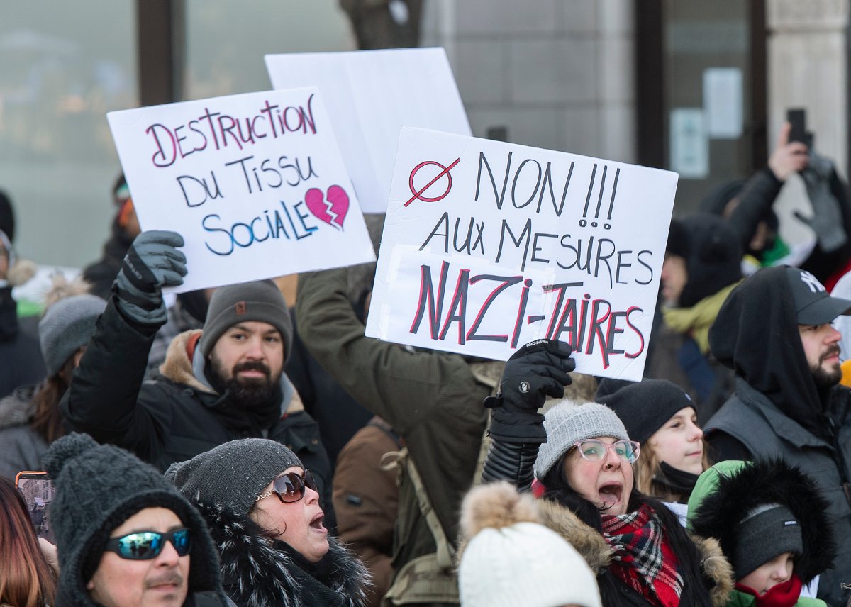 People take part in a demonstration against the Quebec government’s measures to curb the spread of COVID-19 in Montreal, Saturday, Jan. 8, 2022.