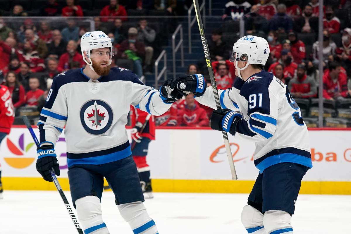 Winnipeg Jets centre Cole Perfetti, right, celebrates his goal with teammate Pierre-Luc Dubois in the first period of an NHL hockey game against the Washington Capitals, Tuesday, Jan. 18, 2022, in Washington. (AP Photo/Patrick Semansky)
