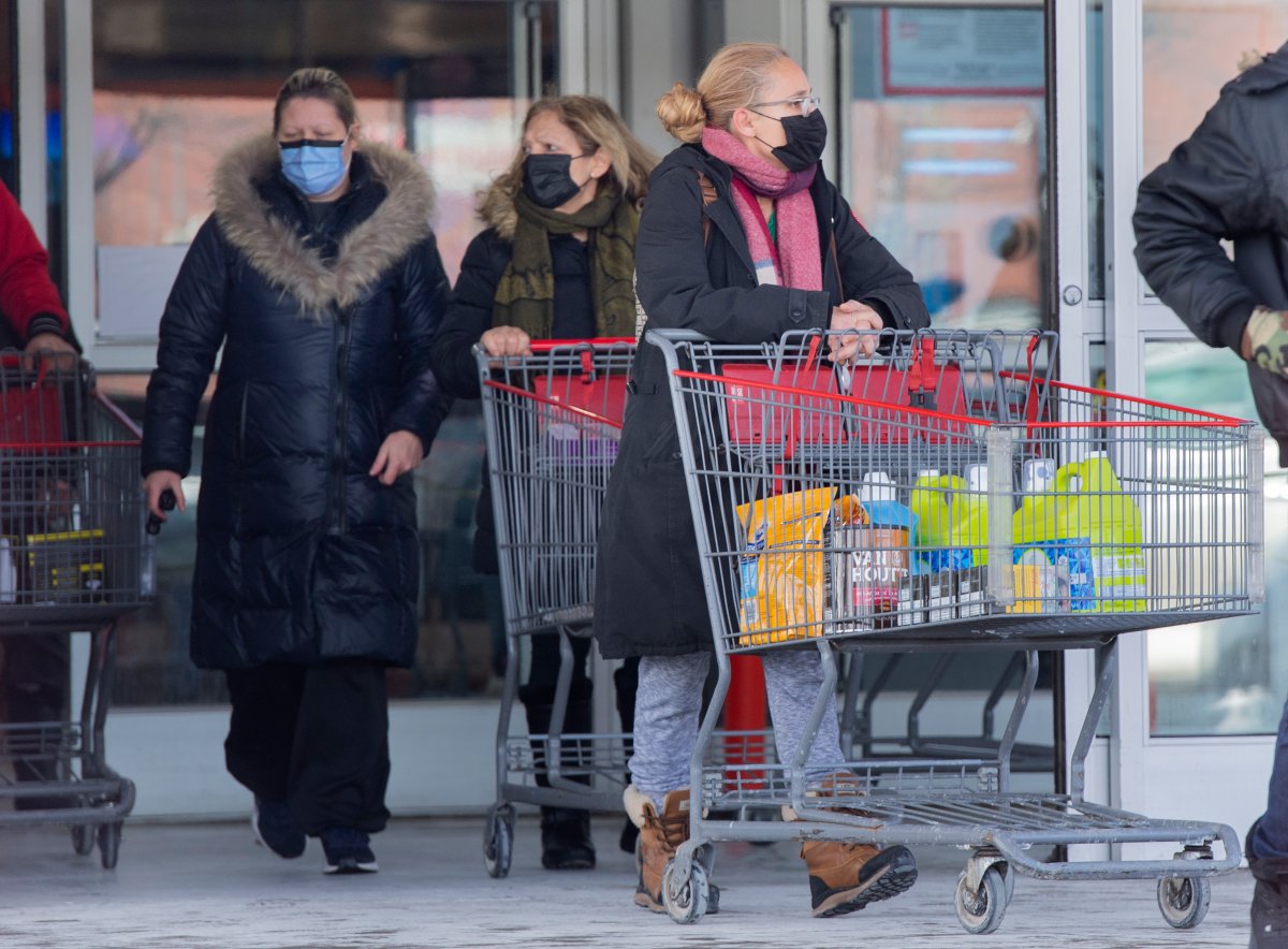 People leave a large box store in Montreal, Sunday, January 23, 2022, as the COVID-19 pandemic continues in Canada. In an effort to curb the spread of COVID-19, vaccine passports will be mandatory to enter the large box stores as of Monday. 