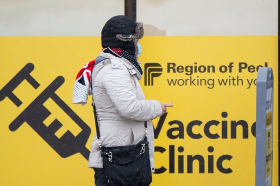 MISSISSAUGA (CANADA), Jan. 22, 2022 A woman wearing a face mask waits outside a COVID-19 vaccine clinic in Mississauga, Ontario, Canada, on Jan. 22, 2022. Canada confirmed 13,555 new COVID-19 cases Saturday afternoon, elevating its national caseload to 2,905,560 with 32,502 deaths, CTV reported. (Credit Image: © Zou Zheng/Xinhua via ZUMA Press)