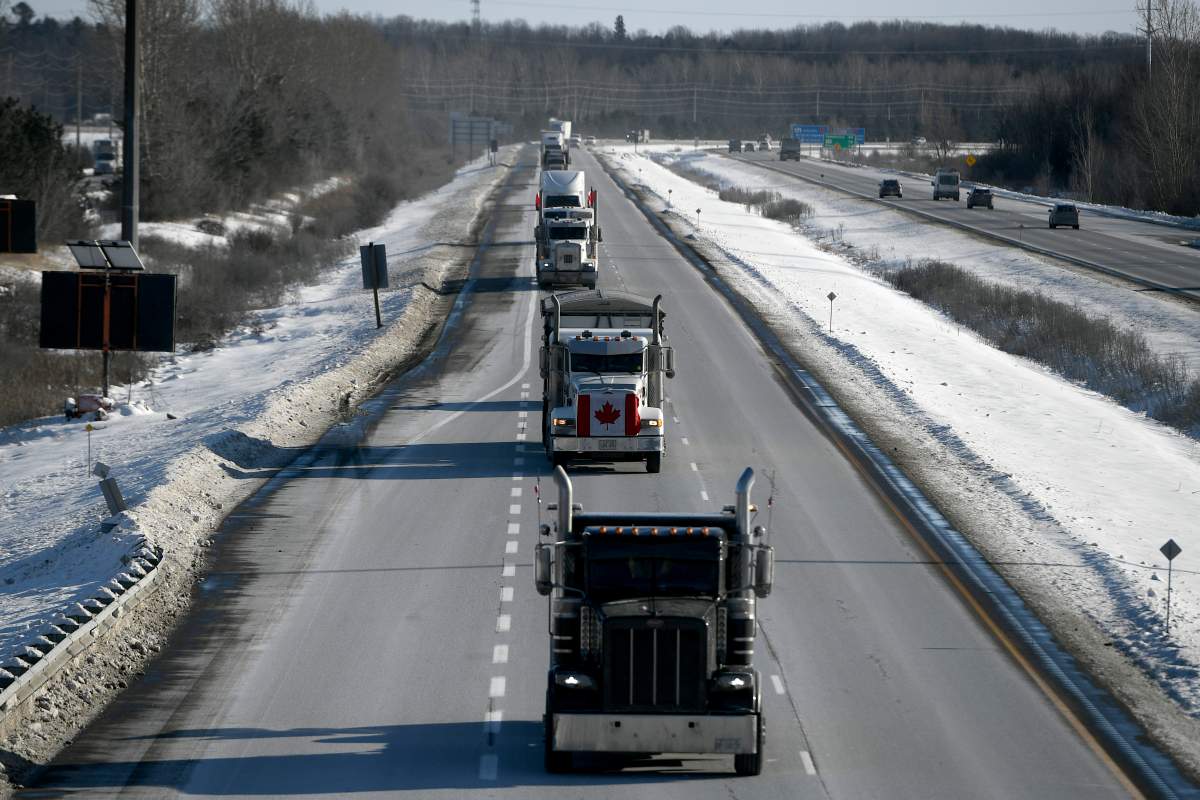 Trucks participating in a cross-country convoy protesting a federal vaccine mandate for truckers, make their way along Highway 416 into Ottawa, Friday, Jan. 28, 2022. THE CANADIAN PRESS/Justin Tang