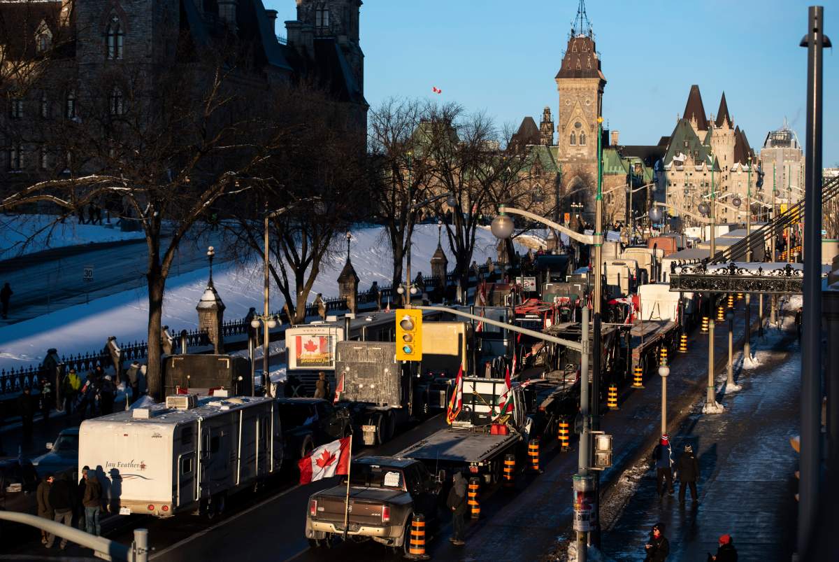 Trucks participating in a cross-country convoy protesting measures taken by authorities to curb the spread of COVID-19 are parked on Wellington Street in front of Parliament Hill in Ottawa, on Friday, Jan. 28, 2022. THE CANADIAN PRESS/Justin Tang