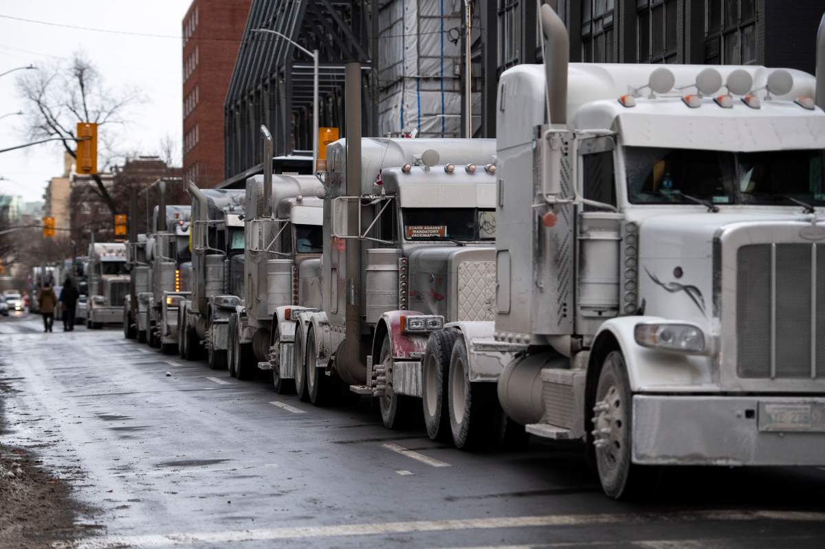 Trucks are parked on Metcalfe Street as a rally against COVID-19 restrictions, which began as a cross-country convoy protesting a federal vaccine mandate for truckers, continues in Ottawa, on Sunday, Jan. 30, 2022. THE CANADIAN PRESS/Justin Tang