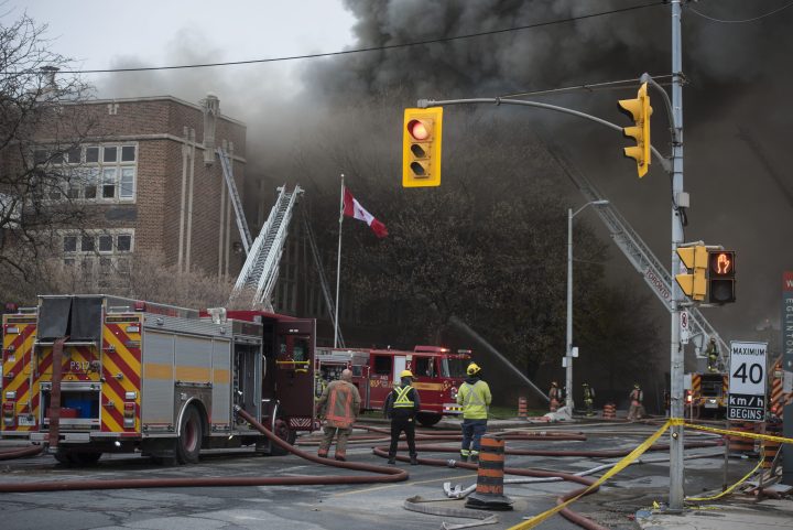 Firefighters work on fire that broke out at York Memorial Collegiate Institute in Toronto on Tuesday, May 7, 2019. 