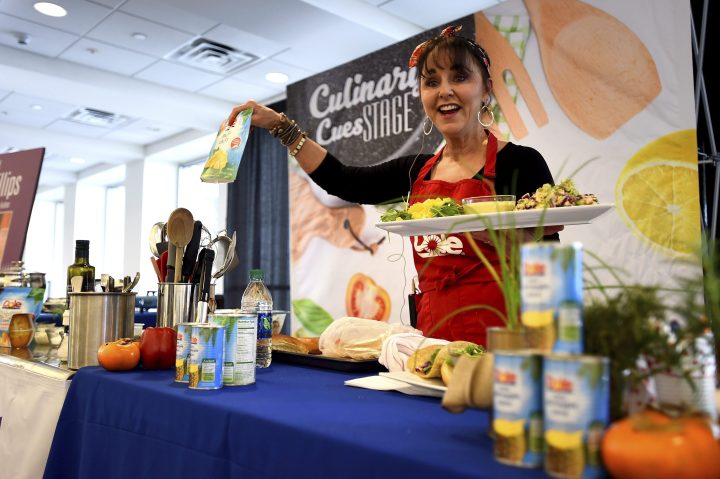 FILE - Ally Phillips serves up Dole Sunshine Mango Kahuna Tuna Salad at the Pasadena Convention Center during the second day of Live on Green! as part of pre-Rose Parade festivities on Saturday, Dec. 30, 2017 in Pasadena, Calif. 
