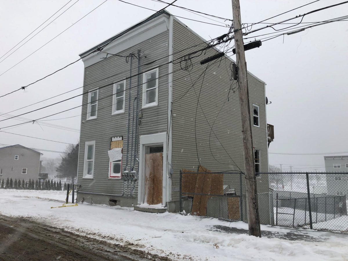 A vacant building damaged by fire at the corner of Charlotte Street and St. James Street in Saint John, N.B., on Jan. 12, 2022. Investigators say the fire is suspicious.