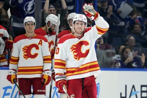 Calgary Flames forward Blake Coleman (20) waves to the crowd after a video tribute during the first period of an NHL hockey game against the Tampa Bay Lightning Thursday, Jan. 6, 2022, in Tampa, Fla. Coleman won a Stanley Cup wile playing for the Lightning.