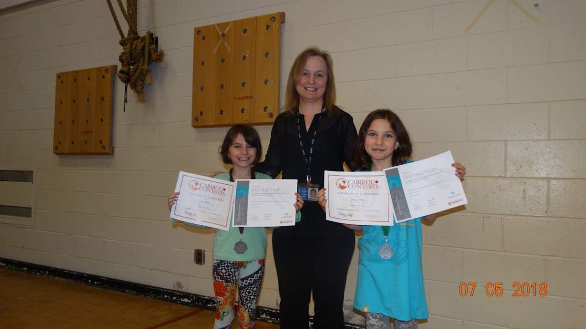 Ana (left) and Maria Mihai (right) are seen with their certificate from two math competitions in 2018.