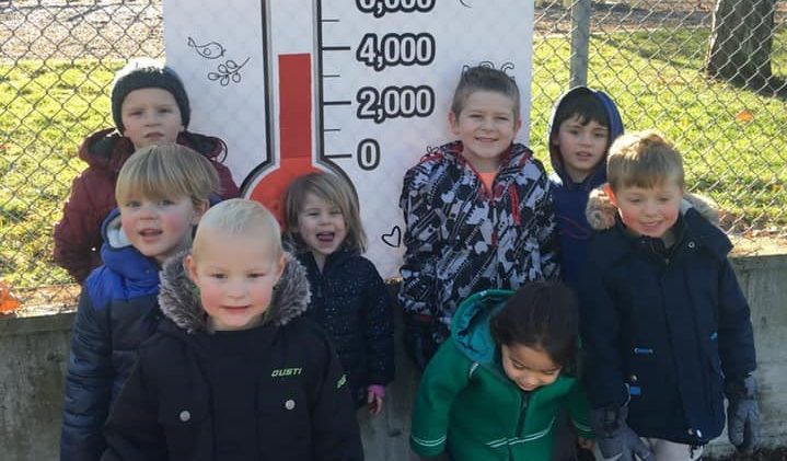 Kids from Naramata Child Development Centre pose in front of the fundraising thermometer, which was donated by JAFA Signs. 