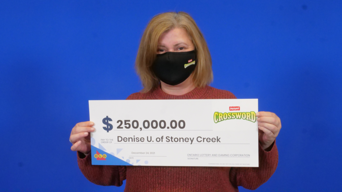 Denise Upton of Stoney Creek celebrating after winning a $250,000 top prize with OLG's Instant Crossword Deluxe.
