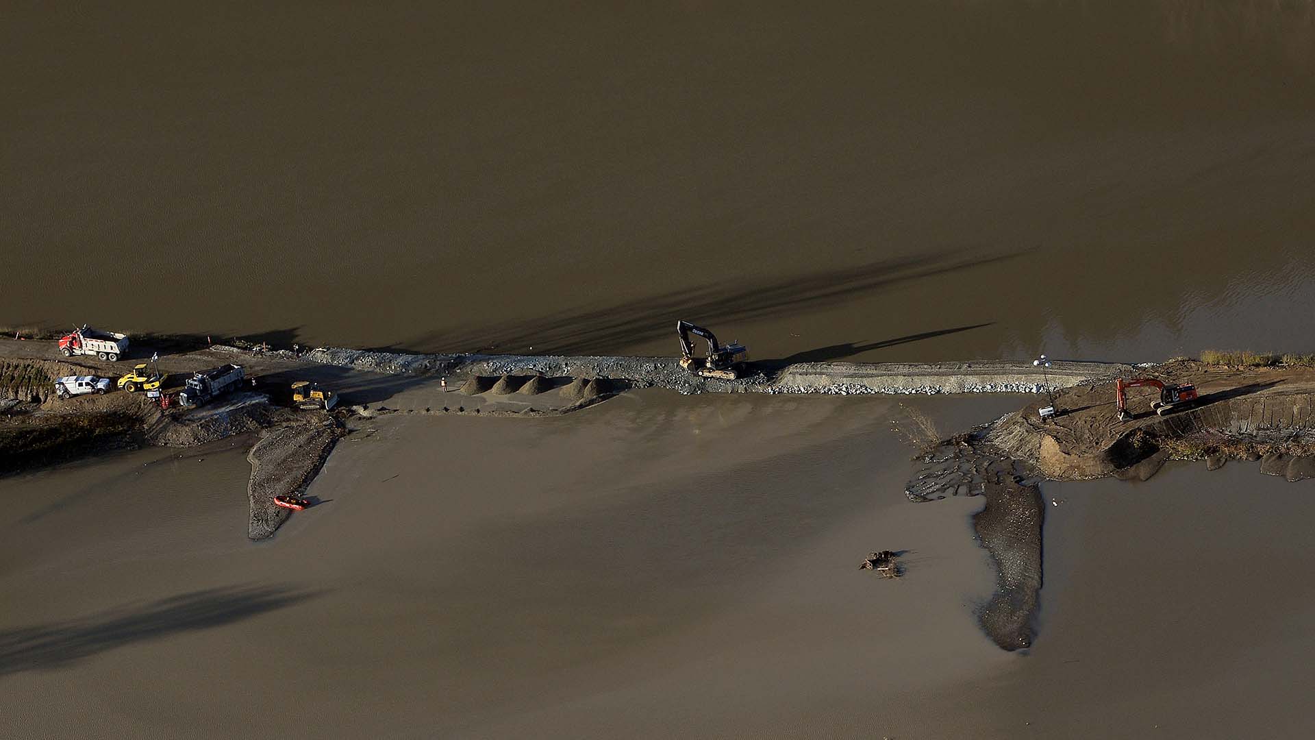 A broken dyke is repaired after rainstorms triggered landslides and floods, shutting highways, in Abbottsford, B.C., on Sunday, November 21, 2021.