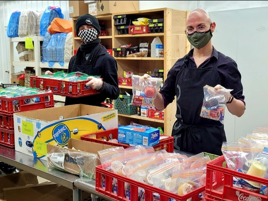 Volunteers at the Saskatoon Food Bank working hard to ensure people know need their services get them