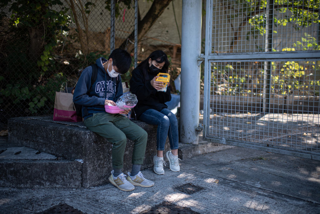 Volunteers take care of hamsters after stopping an owner from surrendering them to the government outside the New Territories South Animal Management Centre on January 20, 2022 in Hong Kong, China.