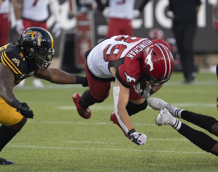 Calgary Stampeders wide receiver Colton Hunchak (89) is tripped up during first half CFL football game action against the Hamilton Tiger-Cats in Hamilton, Ont. on Friday, September 17, 2021. 