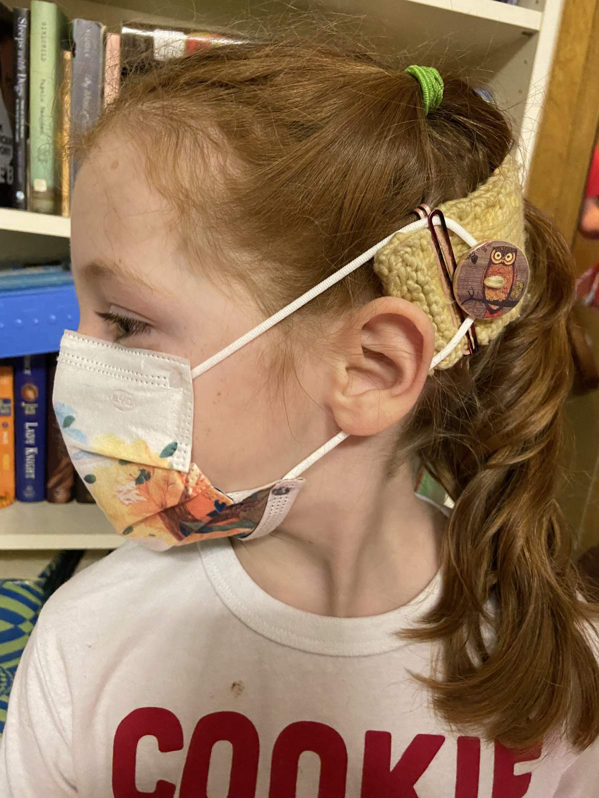 Sarah Mackey’s eight-year-old daughter wearing the mask she was supplied at school with an ear saver.