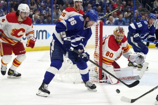 Tampa Bay Lightning right wing Nikita Kucherov (86) tries to control the puck in ront of Calgary Flames goaltender Dan Vladar (80) during the second period of an NHL hockey game Thursday, Jan. 6, 2022, in Tampa, Fla.