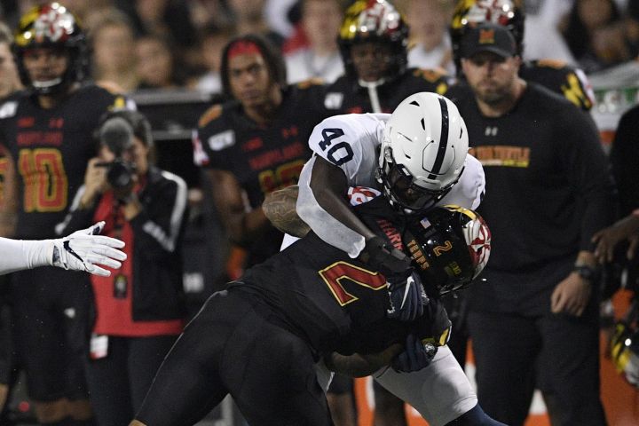 Penn State linebacker Jesse Luketa (40) tackles Maryland running back Lorenzo Harrison III (2) during the first half of an NCAA college football game, Friday, Sept. 27, 2019, in College Park, Md. 