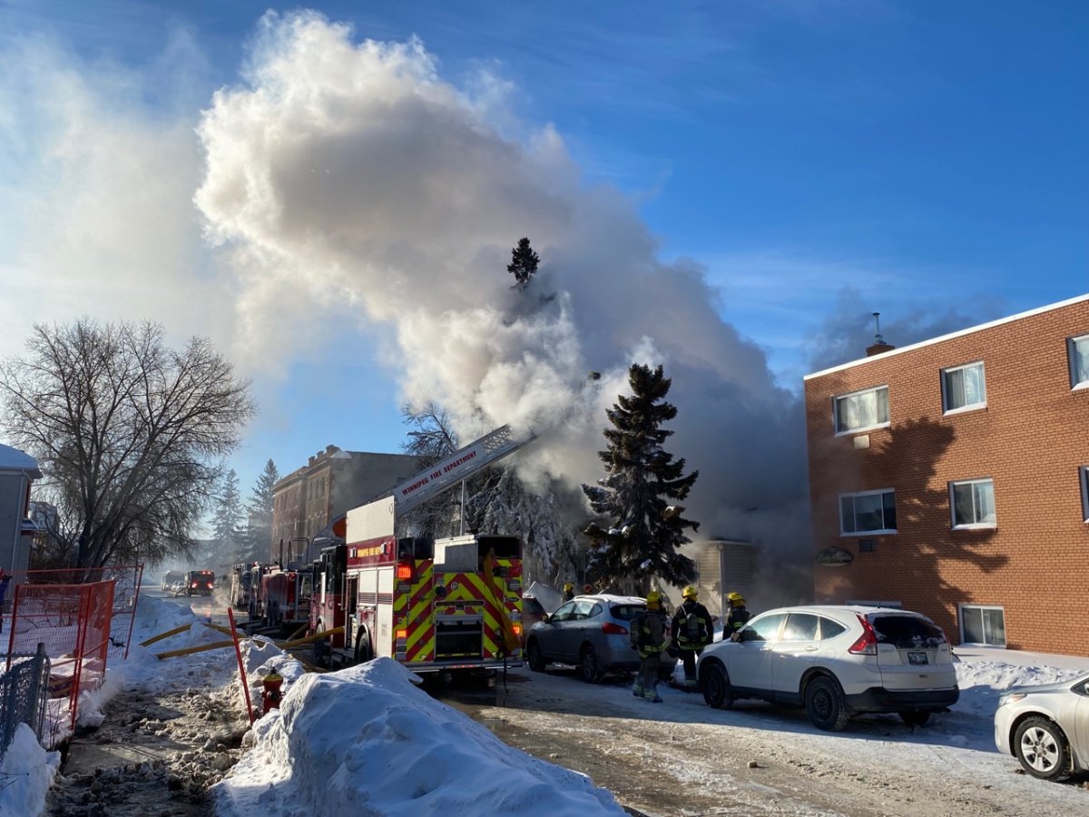 Winnipeg firefighters battle flames on Young Street Thursday morning.