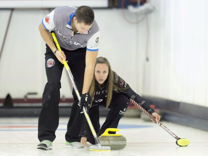 John Morris sweeps for teammate Rachel Homan in the Wall Grain Mixed Doubles Curling Classic at the Oshawa Curling Club in Oshawa, Ont. on Monday November 16, 2015. 