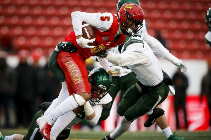 University of Saskatchewan Huskies’ players bring down University of Calgary Dinos’ Jalen Philpot during first half USports Hardy Cup football action in Calgary, Saturday, Nov. 9, 2019.