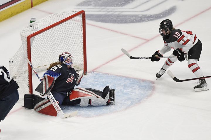 Canada's Marie-Philip Poulin (10) scores a goal against United States goaltender Nicole Hensley during the first period of a women's hockey game in a pre-Olympic Games series Monday, Oct. 25, 2021, in Hartford, Conn. 