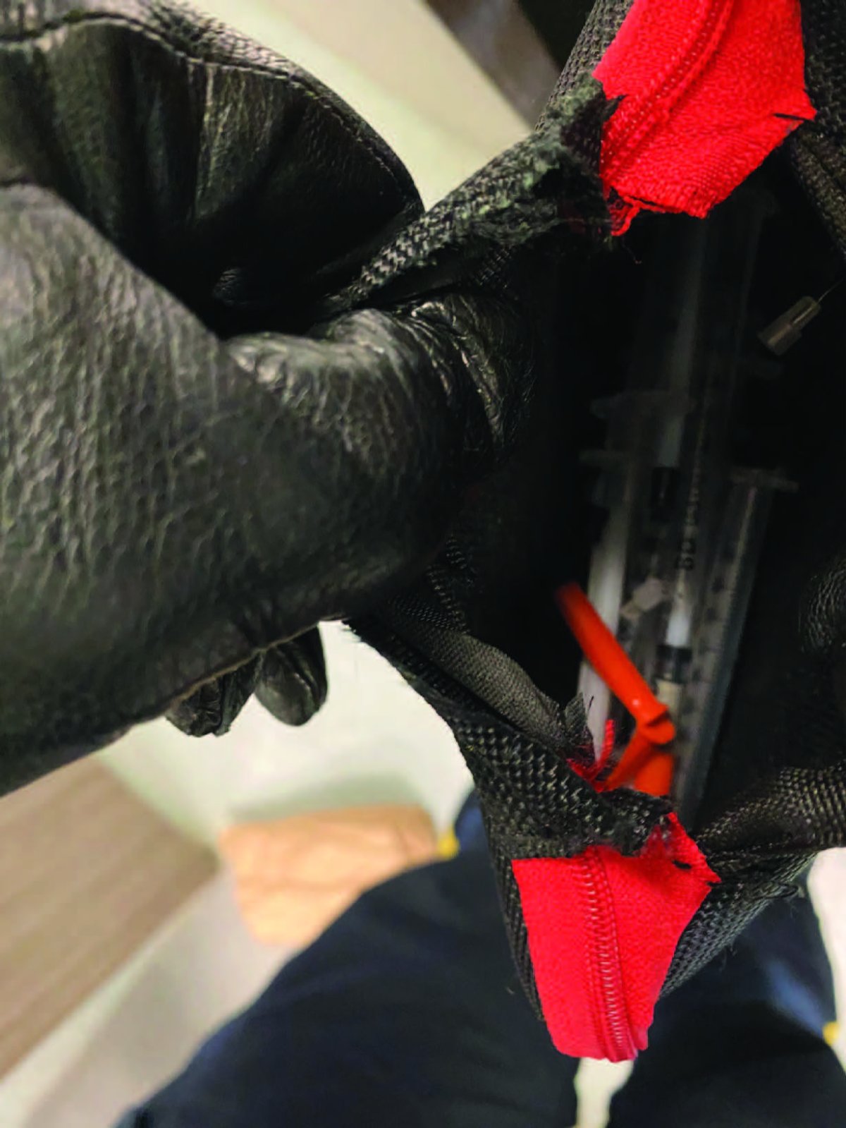 RCMP say a man tossed a bag of used needles at others.