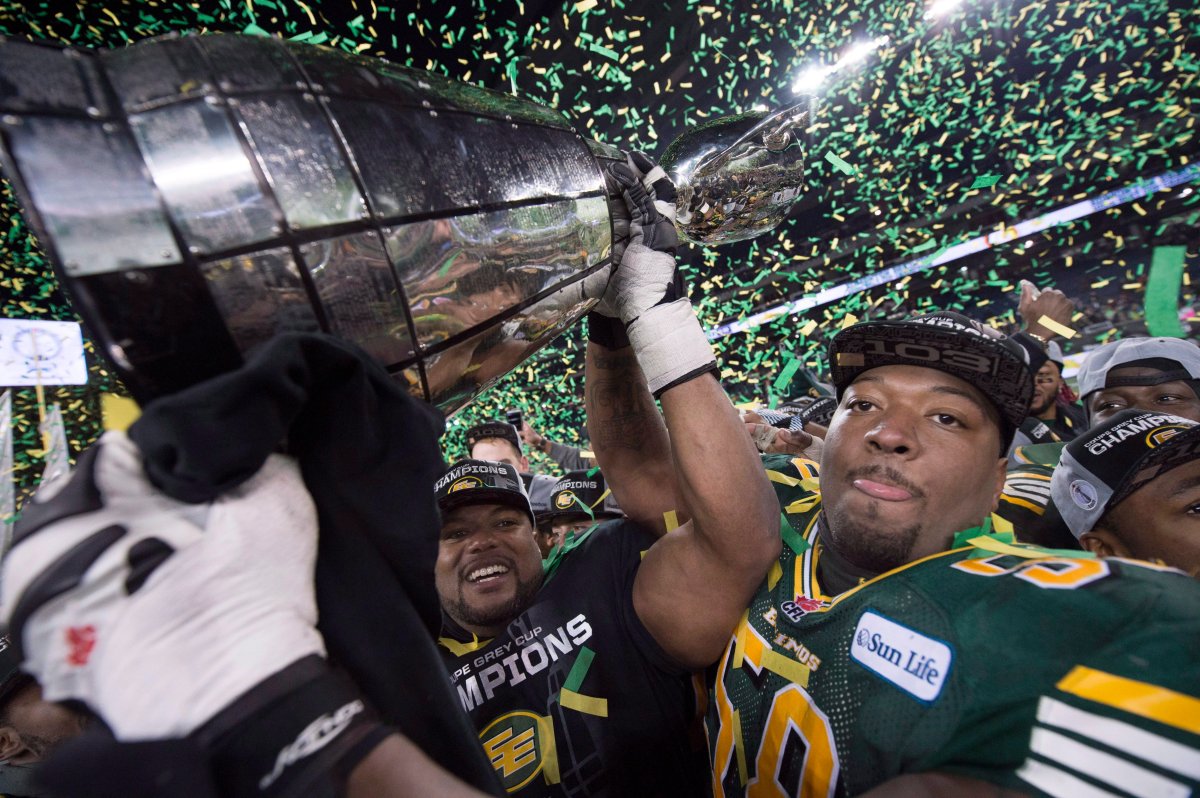 Tony Washington (58) and others members of the Edmonton Football Team hoist the Grey Cup after they defeated Ottawa Redblacks at the 103rd Grey Cup in Winnipeg, Man. Sunday, Nov. 29, 2015. 