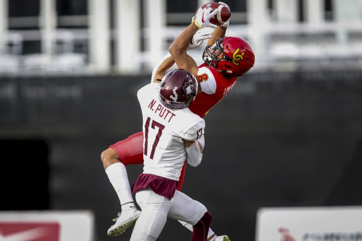McMaster Marauders’ Nolan Putt, left, tries to block University of Calgary Dinos’ Tyson Philpot during first half U Sports Mitchell Bowl football action in Calgary, Saturday, Nov. 16, 2019.