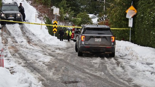West Vancouver Police and firefighters block off access to a Horseshoe Bay, B.C. home where two people were killed on Jan. 2, 2022 after a large tree fell on their house.