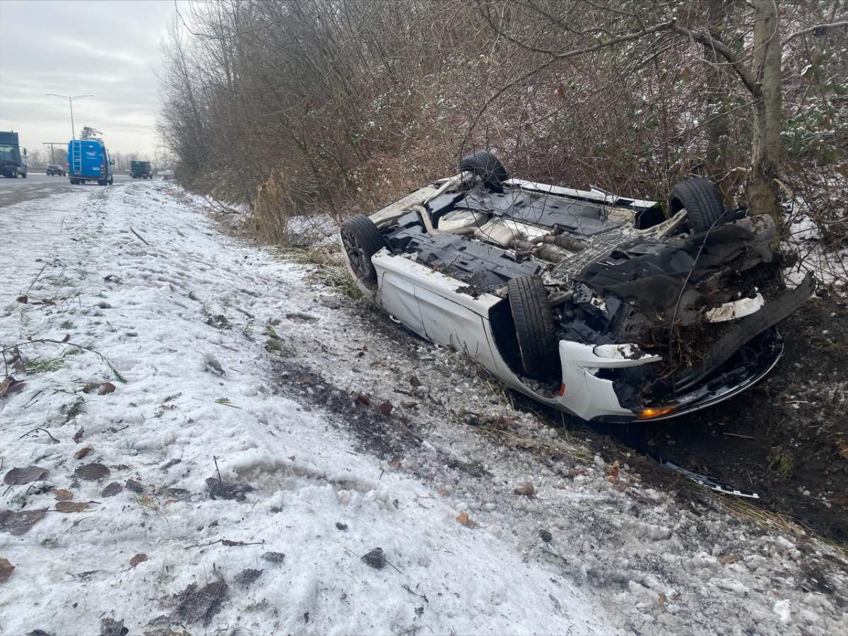 A car flipped into the ditch along Highway 1 near Sprott Street in Burnaby on Wednesday morning.