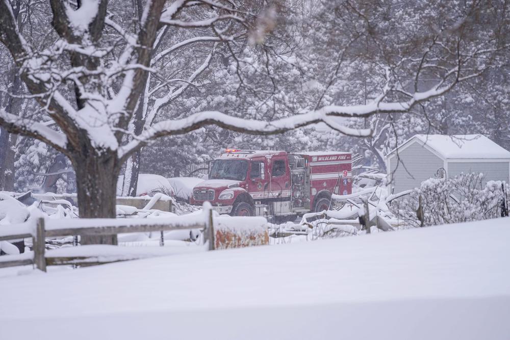 Firefighters patrol the snow covered remains of homes in Louisville, Colo., Saturday, Jan.1, 2022, after the Marshall Wildfire. (AP Photos)
