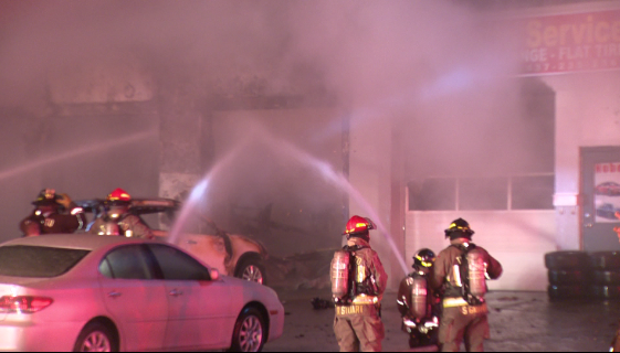 Two people were taken to hospital after a fire at an auto body shop in Toronto. 