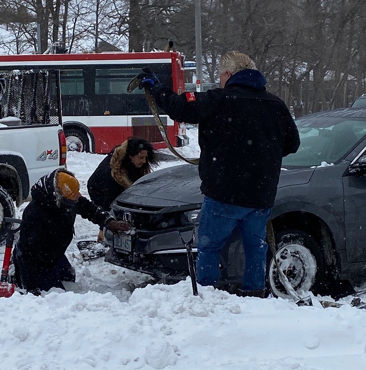 Premier Doug Ford working to free a stuck vehicle following a major storm on Monday, Jan. 17, 2022.