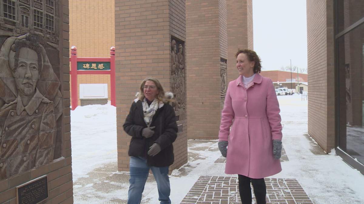 Belinda Crowson (left) and Jenn Schmidt-Rempel (right) approach a pillar dedicated to Lethbridge first female alderman at City Hall.
