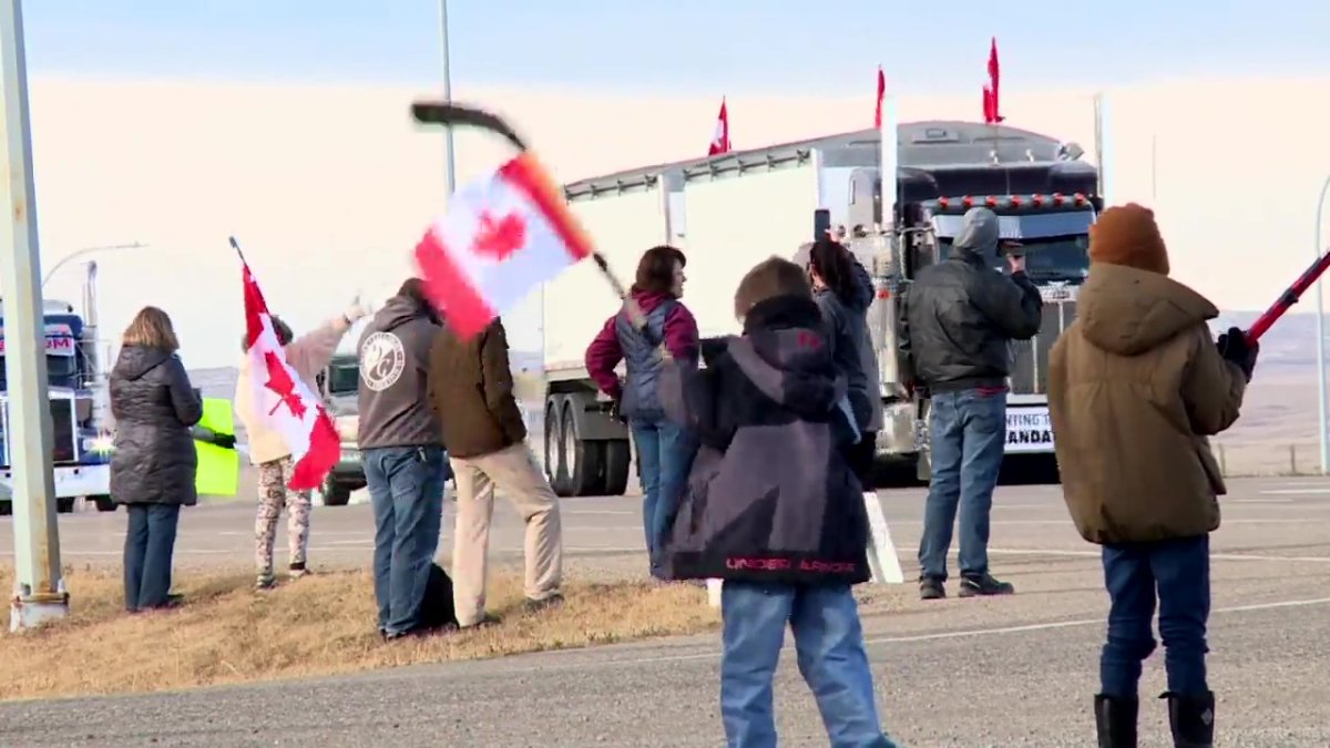 Protestors cheering on a truck convoy near the Coutts border crossing Jan. 29, 2022.