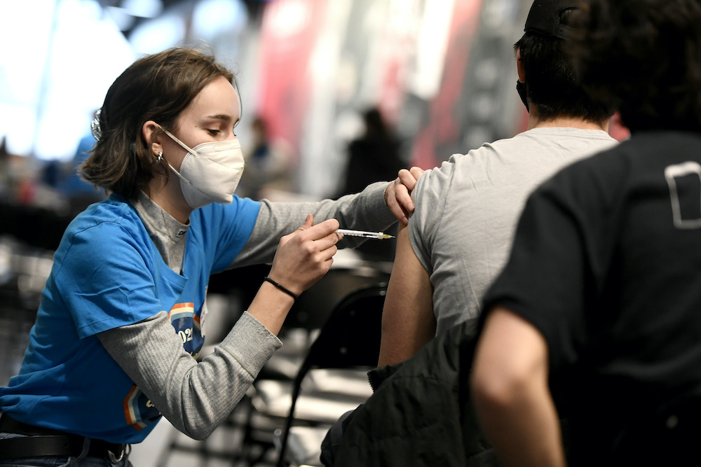 Fourth-year nursing student Mairin Asquin delivers a COVID-19 booster shot at Jabapalooza, a pop up vaccine clinic, in Ottawa, on Monday, Dec. 20, 2021. Another Jabapalooza event prioritizing teachers is set for Sunday, Jan. 9, 2022.