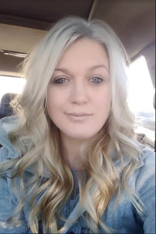 Candice Murley poses for a selfie in her car