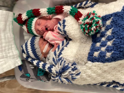 Babies wearing crochet outfits made by the NICU Crocheters.