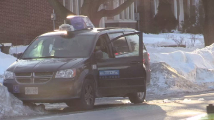 A taxi with a broken window at the scene of a fatal shooting in Oshawa Friday.