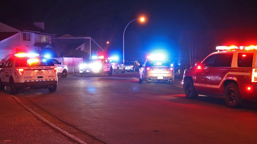 A heavy police presence is seen in the area of 80th avenue and Scott Road after two men were seriously injured in a targeted shooting. Photo: Shane MacKichan.