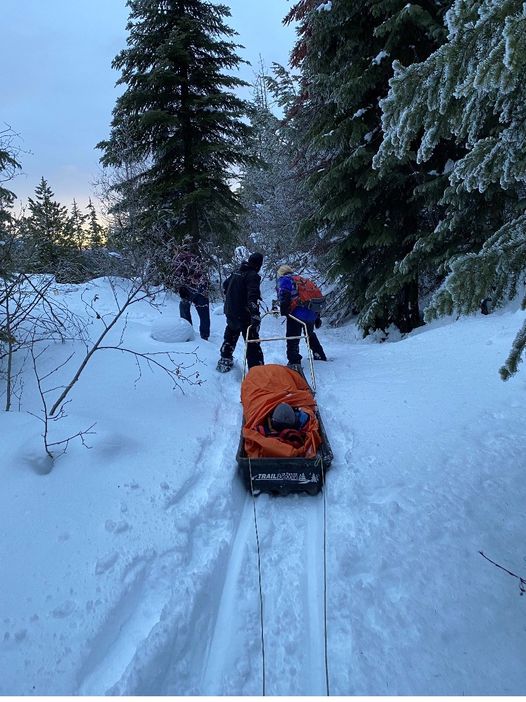 With a  snowmobile team and two toboggans, they went to help a snowshoer who injured his ankle on the SnowView trail in the Kelowna Nordic Trail system and was unable to walk. .