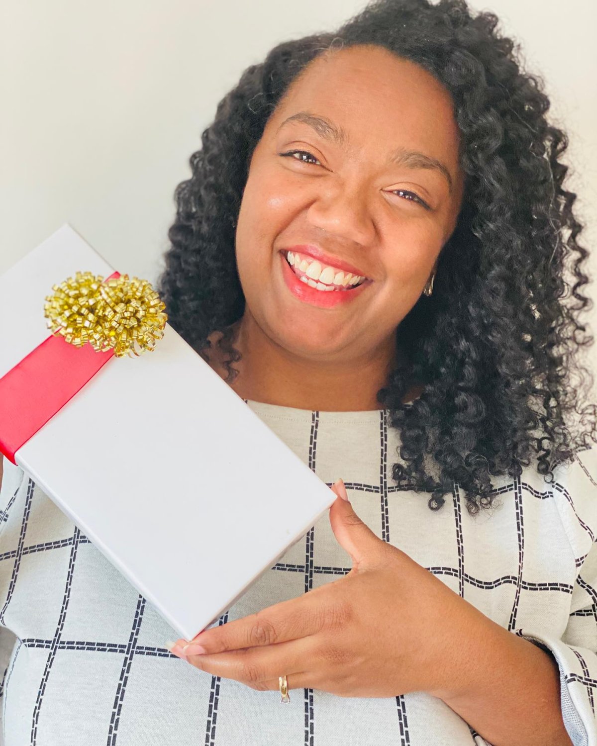 Natural Butter Bar Cosmetics owner Tiffani Young poses with a gift box of products from her business. Young is 1 of 4 women to be featured in the Global News Morning "Celebrating Black Excellence" segment airing during African Heritage Month.