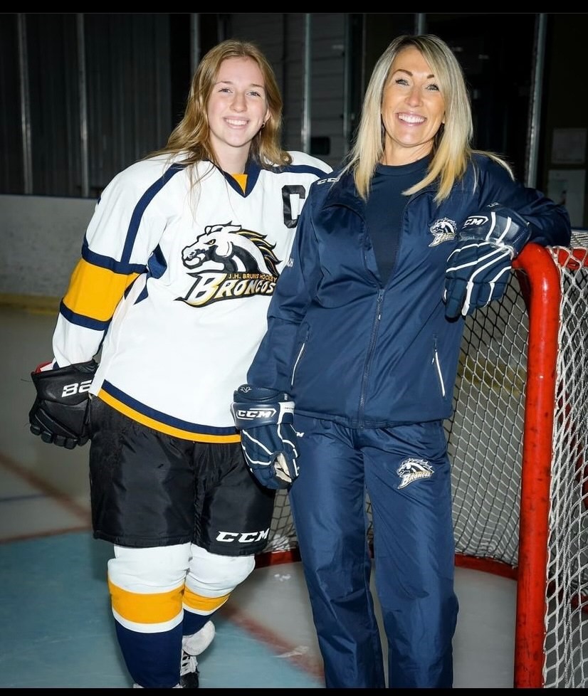 J.H. Bruns student Emma Wallis with teacher Maeve Savage at a high school hockey game.