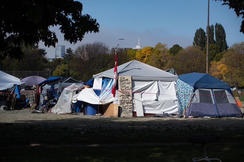 A message is written on a door outside a tent at a homeless encampment at Strathcona Park in Vancouver on Wednesday, October 7, 2020. A new study says the rates of brain injury are endemic among the homeless.THE CANADIAN PRESS/Darryl Dyck.