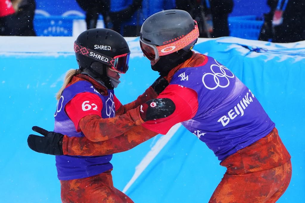 Canada’s Meryeta O’Dine and Eliot Grondin celebrate their bronze medal in mixed team snowboard cross at the 2022 Beijing Winter Olympics in Zhangjiakou, China on Saturday, Feb. 12, 2022. THE CANADIAN PRESS/Sean Kilpatrick